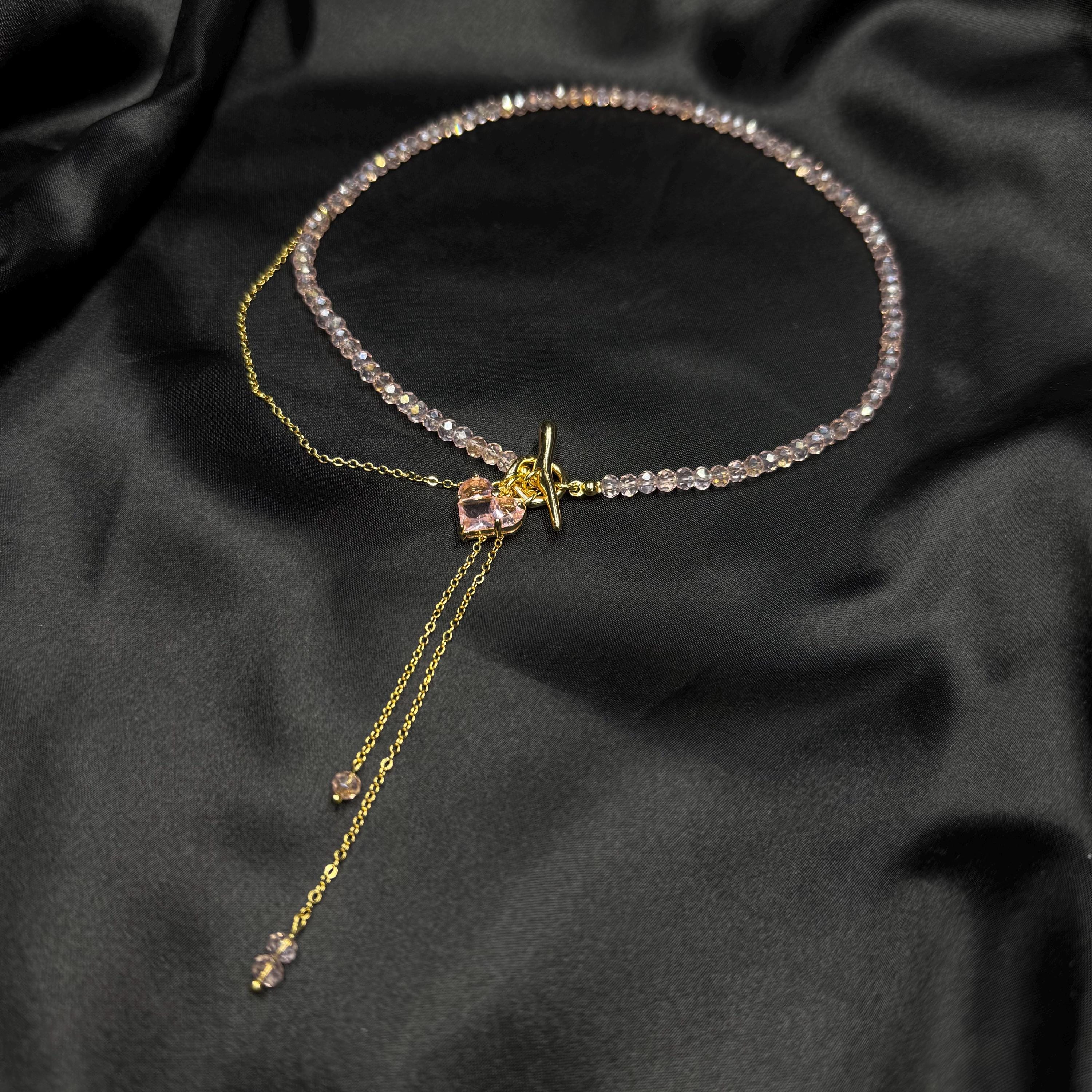 Dainty Lariat Necklace Pink Glass Beads Gold Heart Charm Elegant Minimalist Design Fashion Forward Accessory Feminine Style Statement Choker Length Jewelry Toggle Clasp Feature Romantic Gift Idea Valentines Present Perfect Everyday Wear
